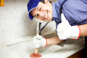 Smiling plumber at work